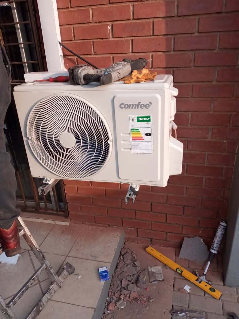 Air conditioner wall unit being installed