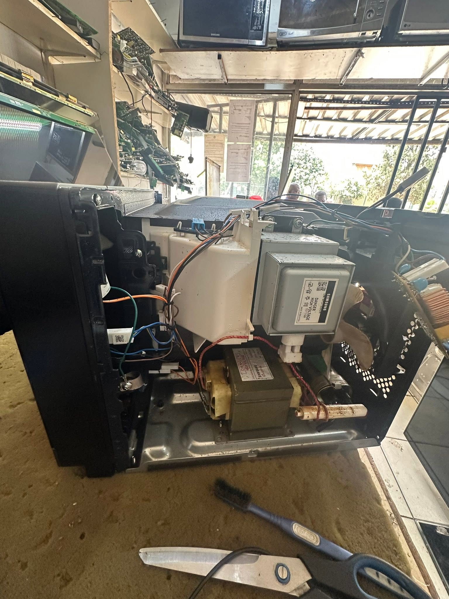 Microwave being repaired on a workbench